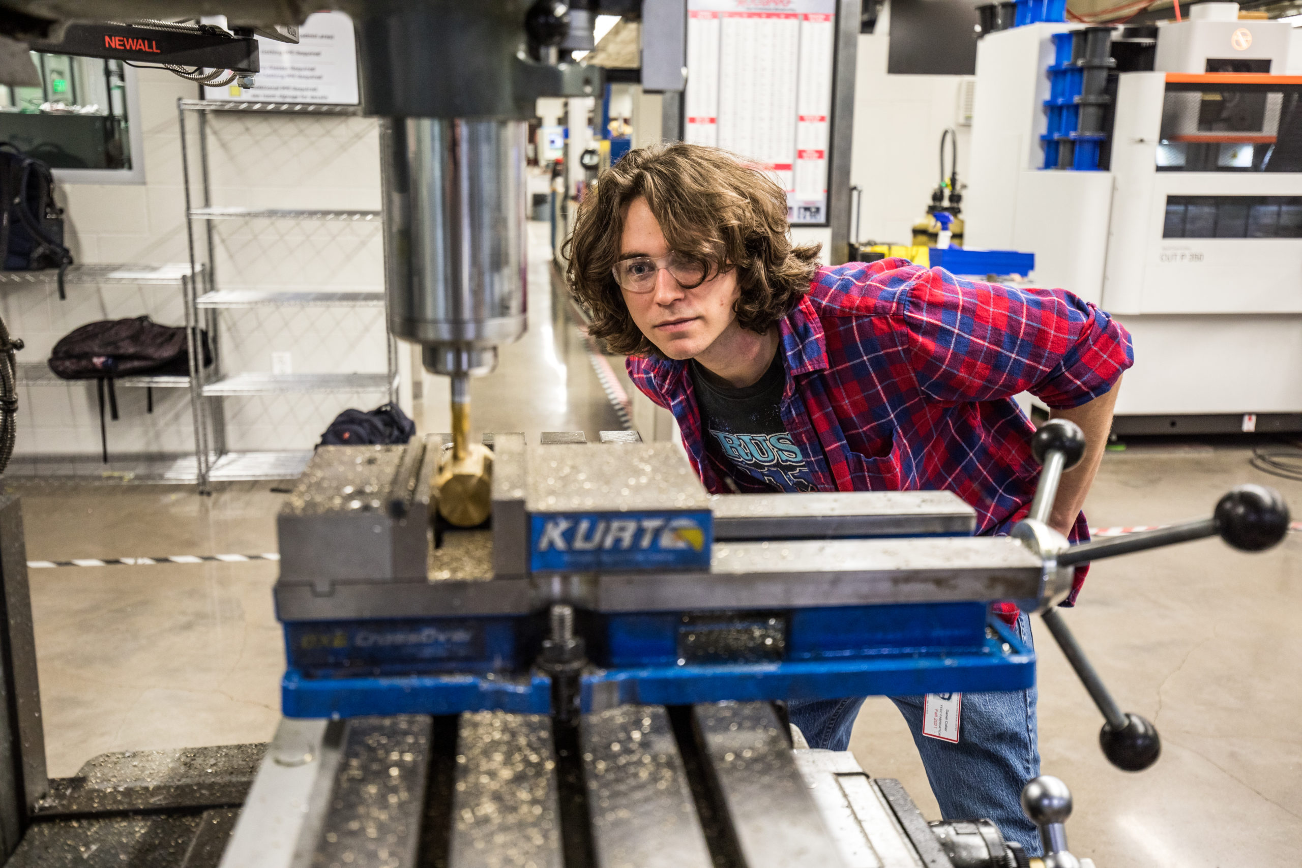 Student milling a part of hammer head
